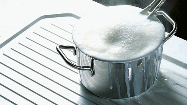 An overcooked pot on a BLANCO stainless steel sink