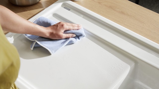 Microfibre cloth cleaning a ceramic sink