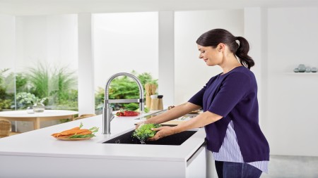 Woman standing at an undermount sink