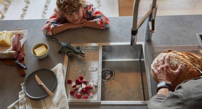 A son watches his father by the sink