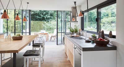 a modern kitchen with an open view into the back yard