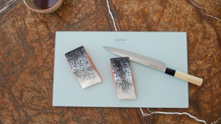 Raw salmon, cut on a BLANCO cutting board